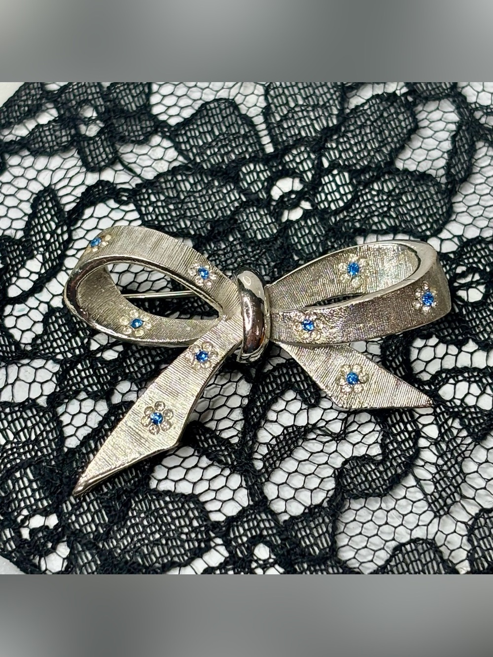 Vintage BSK Silver Bow Brooch with Blue Rhinestones
